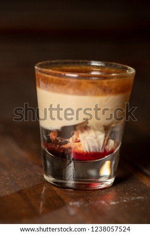 Brain Hemorrhage shot cocktail with schnapps, baileys irish cream and grenadine