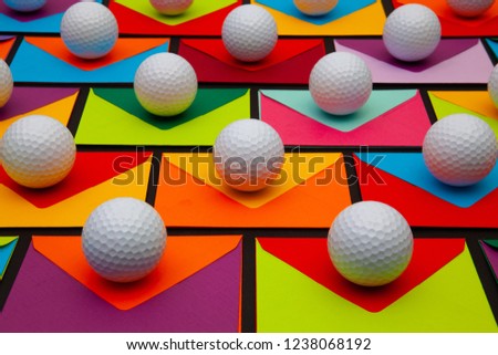 The color envelopes and golf balls on the table. The photo suitable for various holidays and anniversary. 