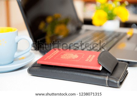 Passport, money and laptop on wooden table. Russian passport . Preparing for travel