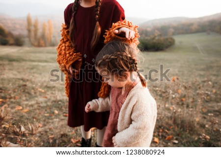 Two girls in vintage clothes are walking in nature. Artistic picture. Rustic style.