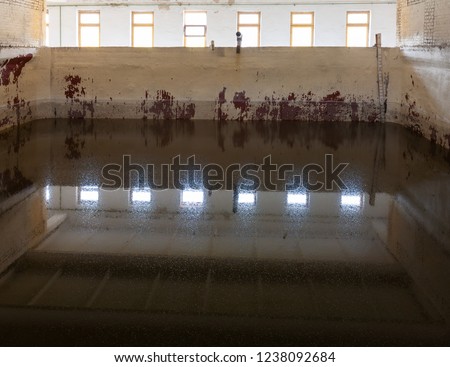 Purification of drinking water. City building. In the frame of the coagulant preparation station. Photographed in Ukraine. Kiev district. Horizontal frame. Color image Royalty-Free Stock Photo #1238092684