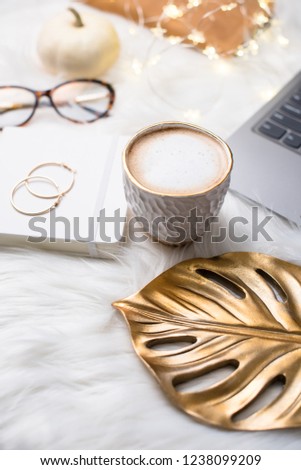 Lady bloggers white work space with gold details, laptop and cof