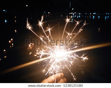 female hand holding sparkler, Celebration concept.