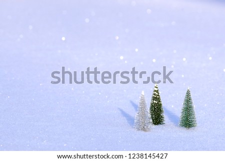Artificial Christmas trees in the snow. Attribute of the new year. ?opy space. Isolate.