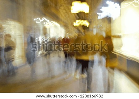 ghostly human figures in old commercial street of Granada, Shopping, night photo, photographic sweep, sensation of movement, blurred people, impressionist photography, abstract, nightlife, atmosphere,
