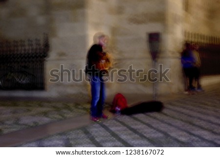 ghost of street musician in the Albaicín, Granada, Spain, Artistic night photographic sweep, sensation of movement, blurred people, impressionist photography, abstract, nightlife, atmosphere, holidays