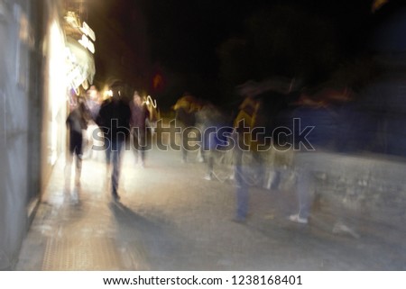 tourists, ghostly human figures in the Albaicín, Granada, Artistic night photographic sweep, sensation of movement, blurred people, impressionist photography, abstract, nightlife, atmosphere, holidays
