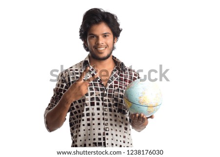 young man with a world globe on a white background.