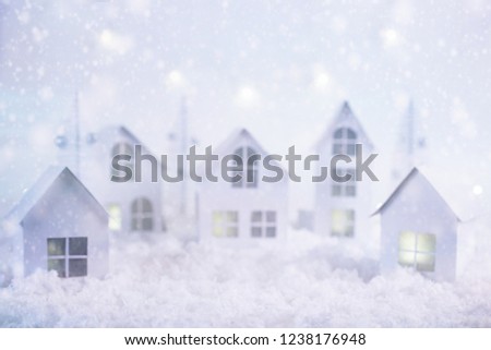 Blurred image of winter Christmas background.Merry Christmas and happy New Year greeting card with copy-space.Christmas landscape. Paper city. Small paper village. Selective  soft focus