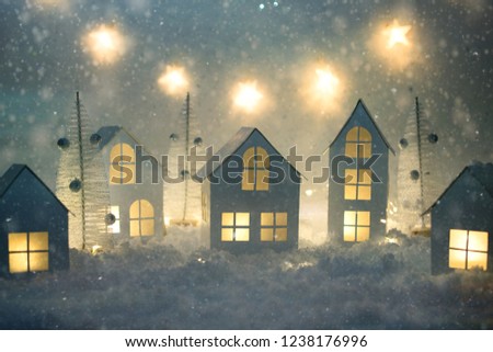 Handmade small white paper city. Small paper village and Christmas lights. Christmas decorations. Holiday concept.