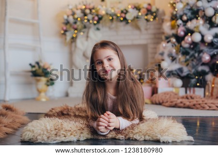 Girl with a gift under the Christmas tree
