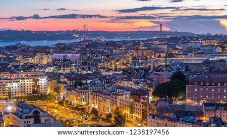 Lisbon after sunset aerial panorama view of city centre with red roofs at Autumn day to night transition timelapse, Portugal. Top view from Miradouro da Nossa Senhora do Monte viewpoint Royalty-Free Stock Photo #1238197456