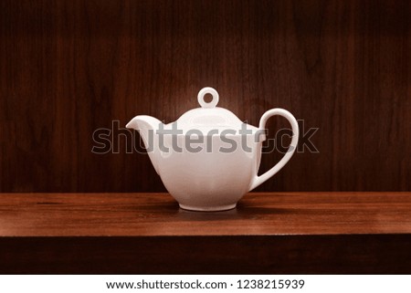 Picture of teapot on wooden table. Overhead view, copy space.