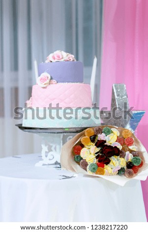 Festive cake and bouquet of sweets