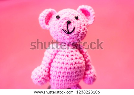 Funny pink manufactured teddy bear, a concept image for a newborn baby girl, expecting a baby illustrative image.