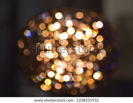 Blurred bright abstract gold bokeh lights round shape.