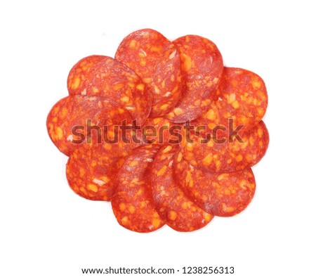 Spicy salami sausage slices isolated on white background, top view