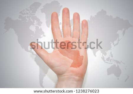 hand with map of paraguay on the gray world map background. concept