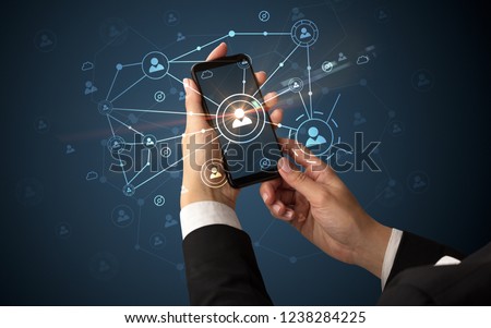 Female hand using smartphone to connect peoples all around the online surface