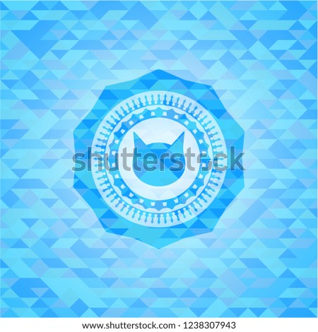cat face icon inside realistic light blue emblem. Mosaic background