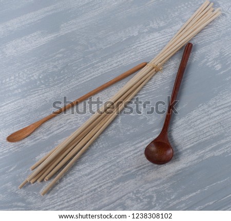 spoons for spices, chopsticks on a wooden background, composition for oriental restaurants