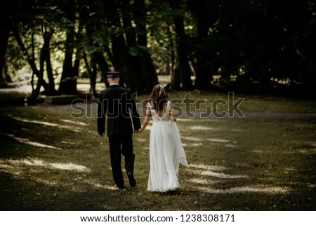 A young couple is walking in front of you.