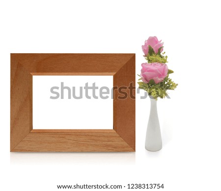 front view wooden frame and pink rose in white ceramic vase on white background,copy space