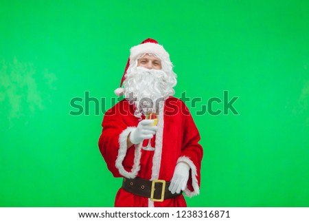 santa claus celebrating christmas with champagne glass isolated on green