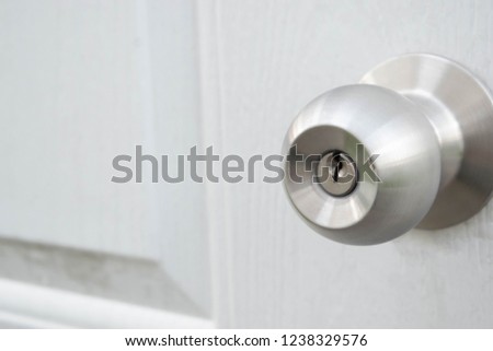 Modern white door with crack door knob look little old.