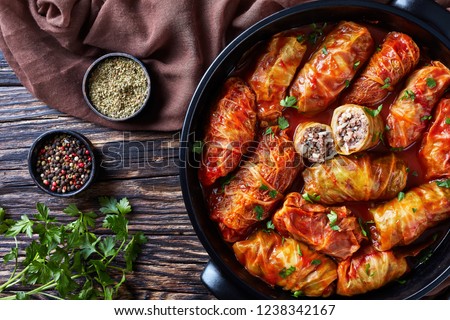 overhead view of cabbage rolls stuffed with ground beef and rice and baked to perfection with a tangy tomato sauce in dutch oven, flatlay, close-up Royalty-Free Stock Photo #1238342167