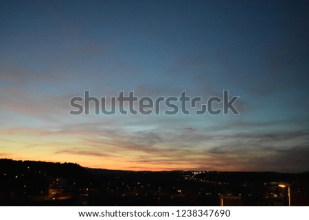 evening view over the landscape at night time sunset street lights gold orange blue sky collar in Teruel Spain. 
