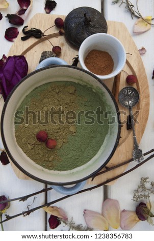 Beautiful vertical layout - henna and cinnamon for dyeing hair on a white wooden table