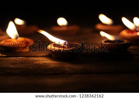 Traditional Thai candles in Thai Loy Krathong Festival, light in lantern . lamp in small earthenware cup. Blurred image.