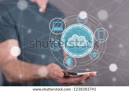 Cloud technology concept above a smartphone held by a man in background