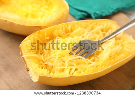 Cooked spaghetti squash and fork on table Royalty-Free Stock Photo #1238390734