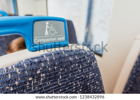 Close up of handle or handheld seat for disability people in train, tube and underground in Europe. Priority seat for disability people concept.