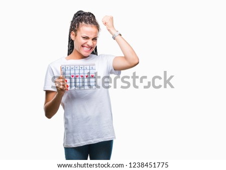 Young braided hair african american girl holding menstruation calendar over isolated background annoyed and frustrated shouting with anger, crazy and yelling with raised hand, anger concept