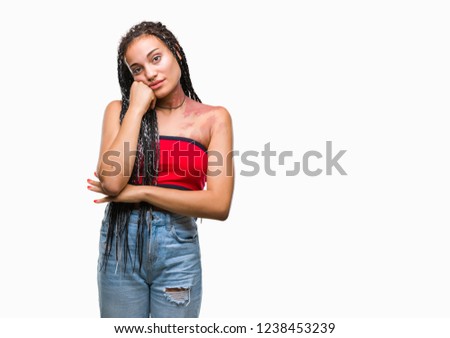 Young braided hair african american with pigmentation blemish birth mark over isolated background with hand on chin thinking about question, pensive expression. Smiling with thoughtful face. Doubt