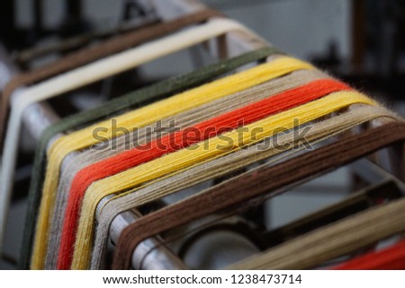 Yellow And Other Colors Of Virgin Wool. Threads On The Old Textile Machine. Small Textile Industry in Germany. Abstract Vintage Background.  Royalty-Free Stock Photo #1238473714