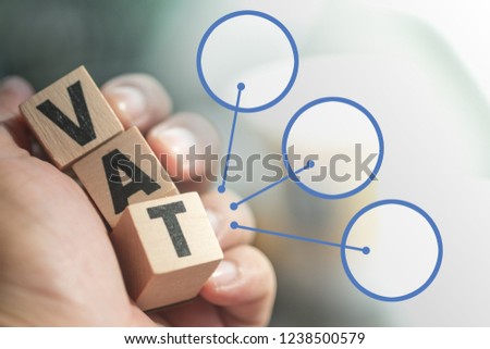 Wooden letter blocks the word tax on hand. Concept of government tax analysis