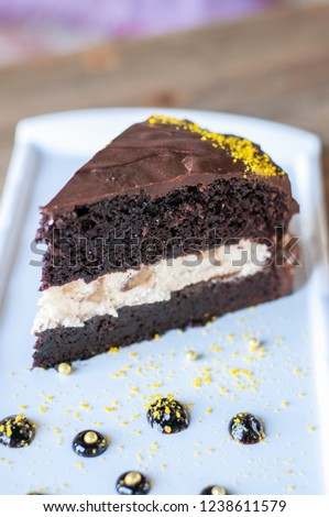 Banana chocolate cake with chocolate pieces on the plate on wood table