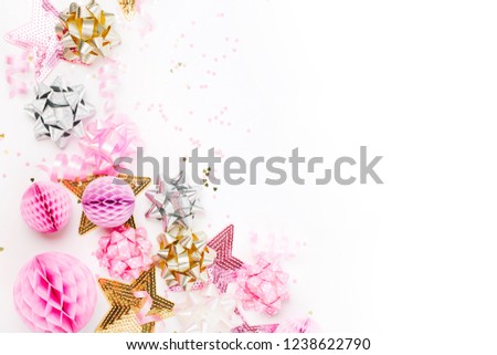 Pastel Pink confetti, bows and paper decorations. Flat lay, top view. Holiday composition for birthday party, New year/Christmas celebration or hen party  concept theme. Flat lay, top view