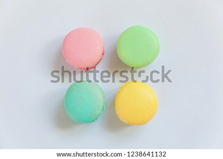 Sweet almond colorful pink, biue, yellow, green macaron or macaroon dessert cake isolated on white background. French sweet cookie. Minimal food bakery concept. Flat lay, top view, copy space