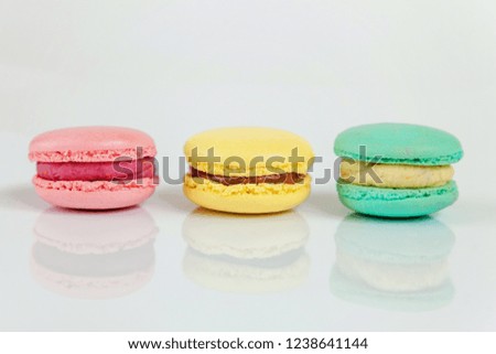 Sweet almond colorful pink, biue, yellow macaron or macaroon dessert cake isolated on white background. French sweet cookie. Minimal food bakery concept. Copy space