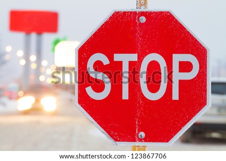 Stop road sign in snowy day in winter. Canada