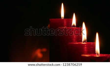 4 burning red candles right Position with dark background