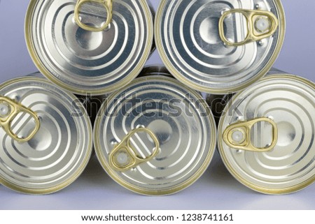 Can with meat dish on a white table. Canned food with a long shelf life. Light background.