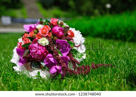 Bridal bouquet of flowers on the grass background