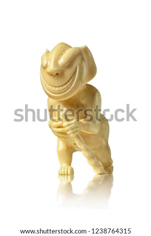 Peliken - an Eskimo and Chukchi talisman carved from the walrus tusk, the figure of a walking, smiling creature with a staff