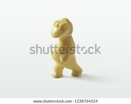 The figure of the walking Billiken, Chukchi traditional northern souvenir-amulet, on a light background